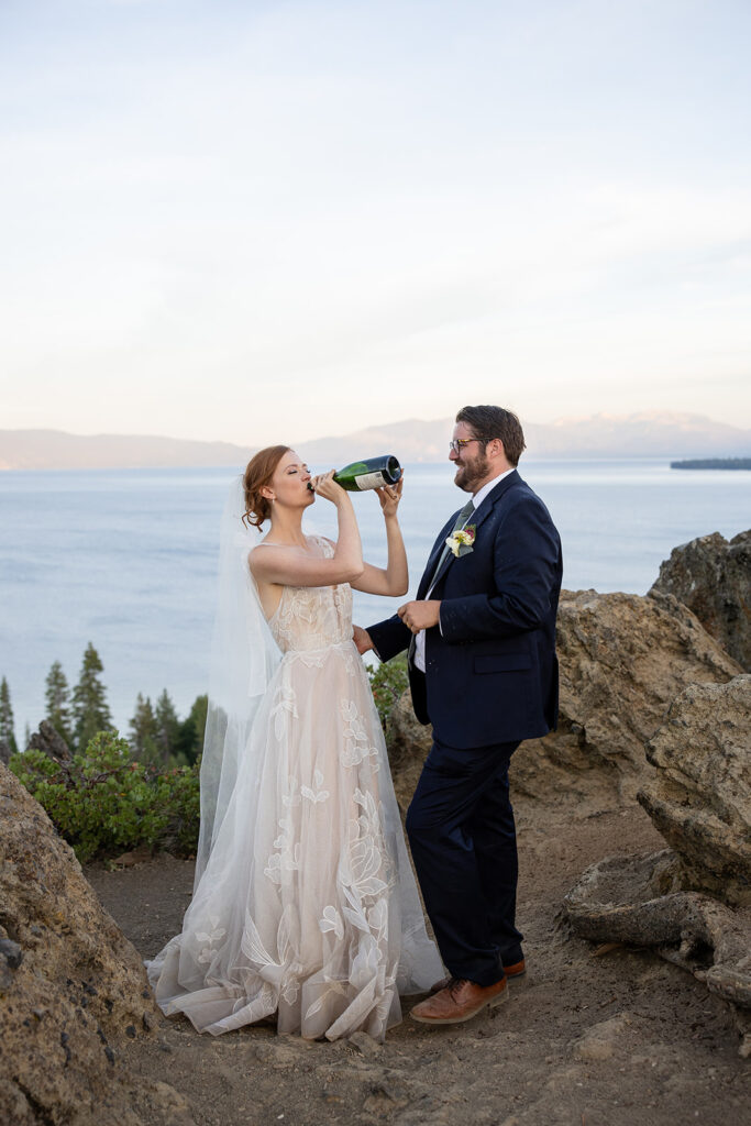 bride and groom popping champagne at a mountain overlook in lake tahoe
