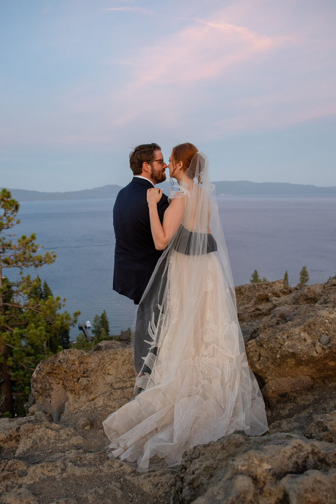 romantic bride and groom at a lake tahoe mountain overlook