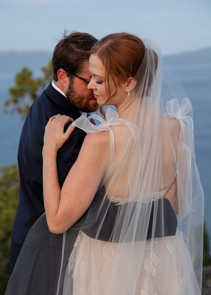 romantic bride and groom at a lake tahoe mountain overlook