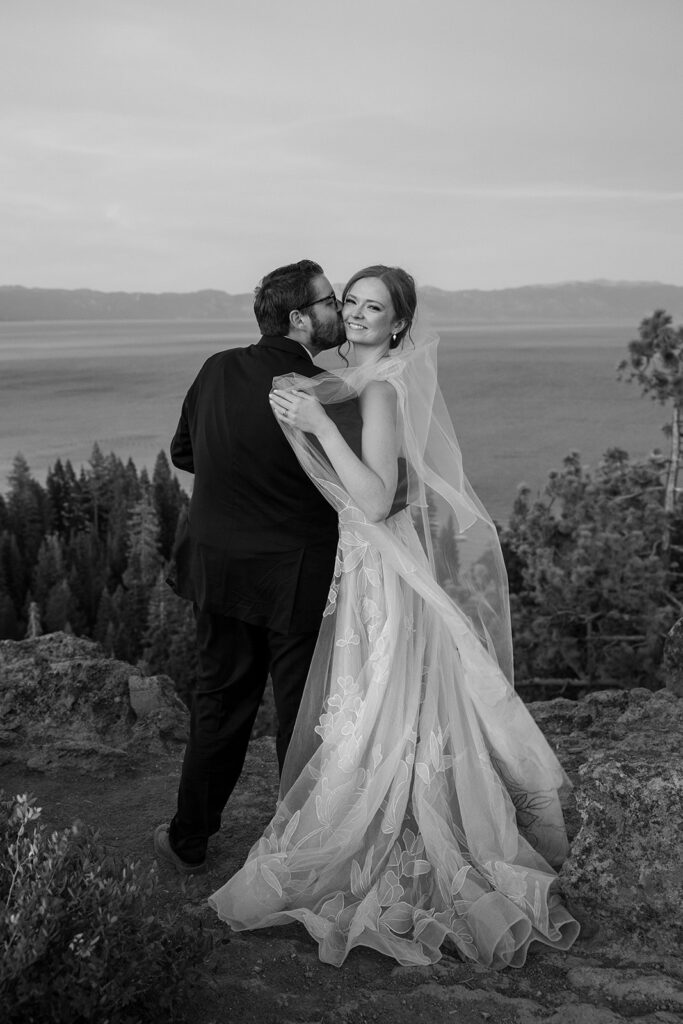 romantic bride and groom at a lake tahoe mountain overlook