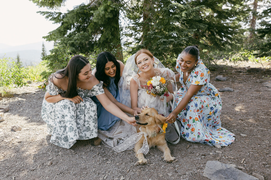 bride and her friends posing with the dog