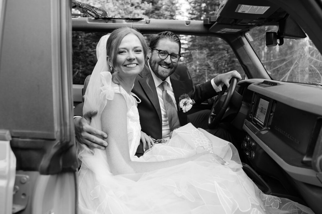 bride and groom inside their jeep