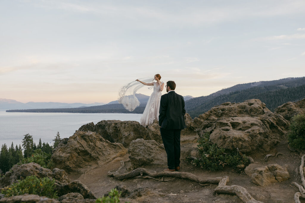 romantic bride and groom at a lake tahoe mountain overlook