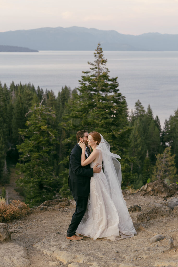 bride and groom hugging on a mountain overlook during their Lake Tahoe adventure elopement
