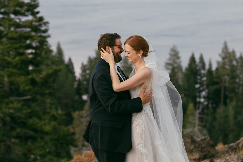romantic bride and groom at a lake tahoe mountain overlook