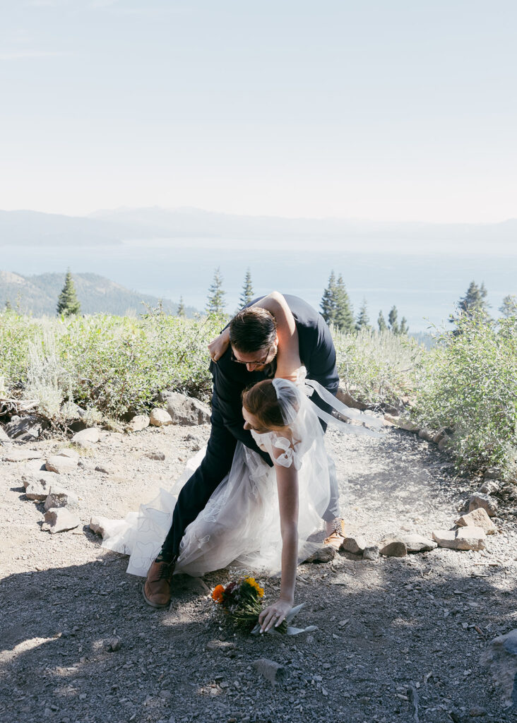 playful bride and groom photos at a mountain overlook during their adventure elopement in Lake Tahoe