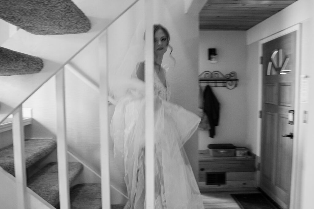 bride heading down the stairs of the airbnb