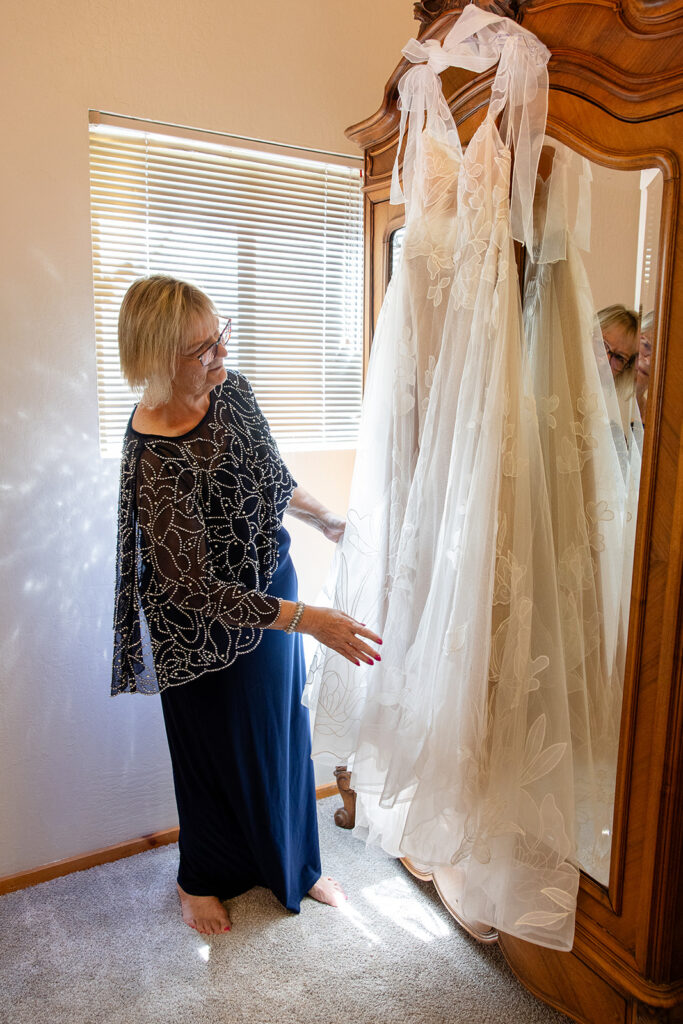 bride's mom arranging the wedding dress