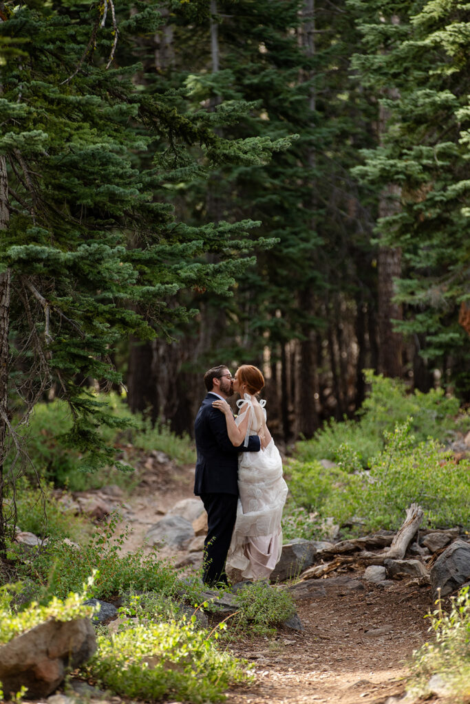 bride and groom roaming around the forest during their lake tahoe adventure elopement
