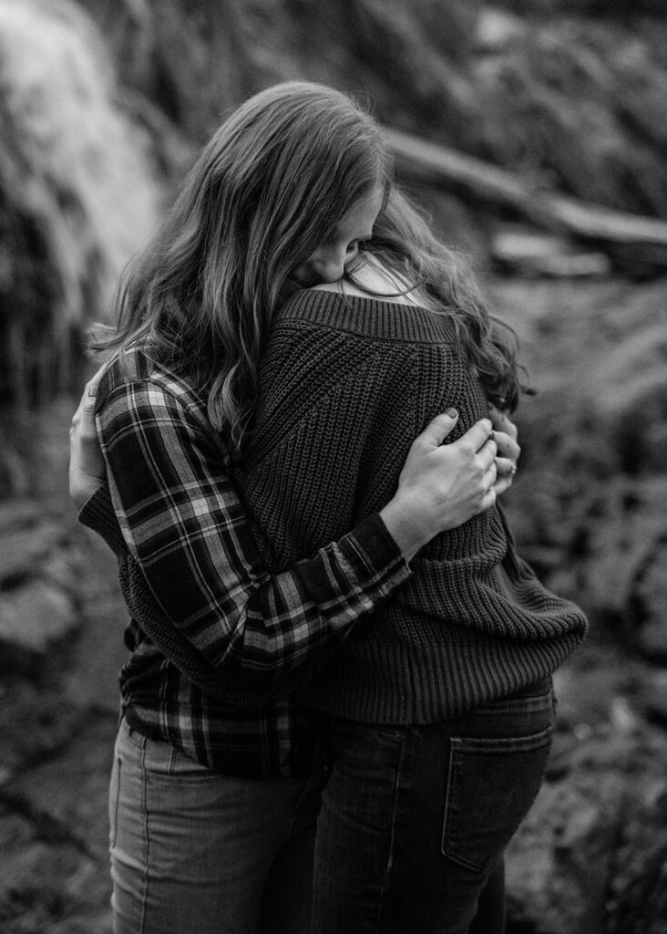 sweet queer couple during their waterfall engagement photos at glen alpine falls