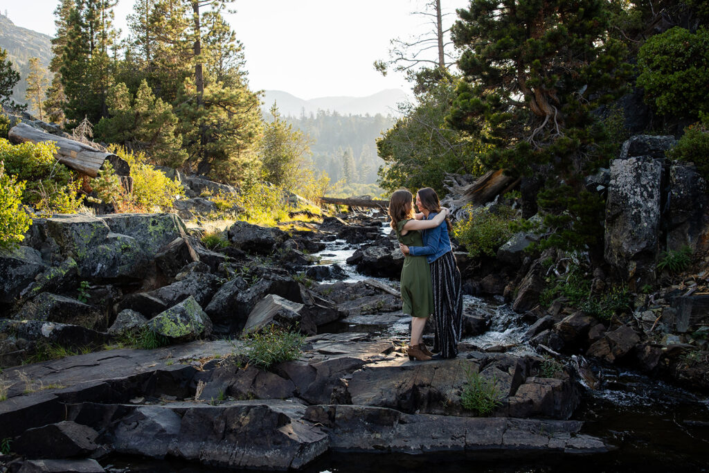 sweet queer couple during their waterfall engagement photos at glen alpine falls