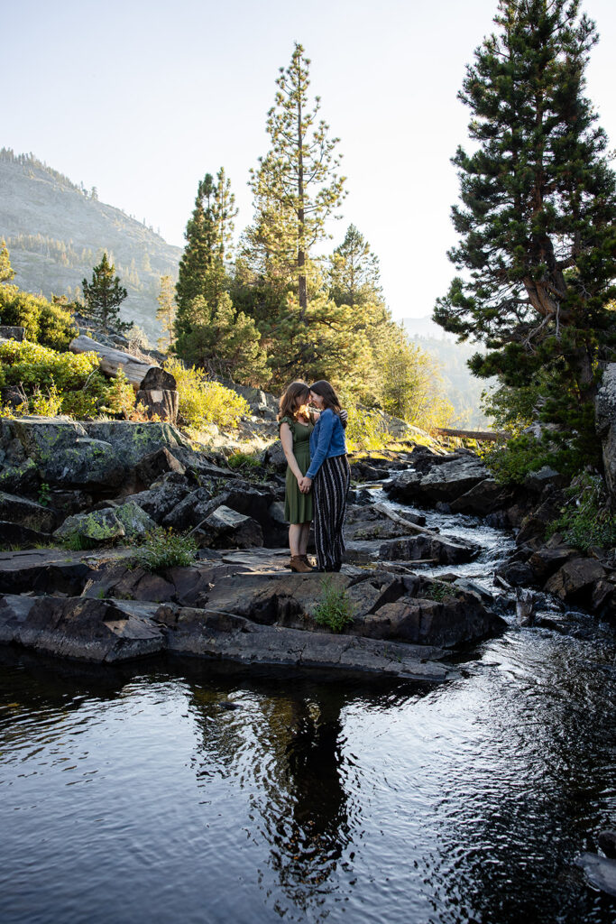 adventurous queer couple surrounded by water views during their Lake Tahoe engagement session