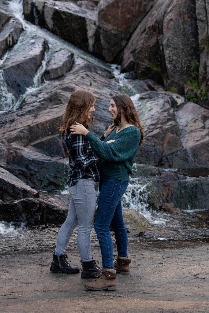 sweet queer couple during their waterfall engagement photos at glen alpine falls
