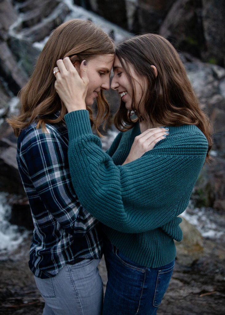 sweet queer couple during their waterfall engagement photos at glen alpine falls