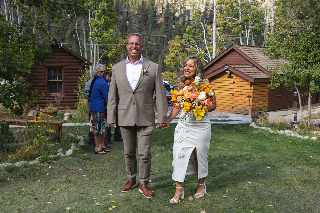 bride and groom holding hands during their desolation lake micro wedding